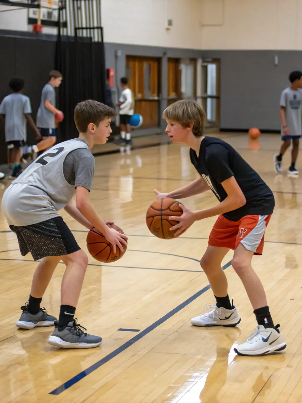 A high-energy image of young basketball players practicing dribbling skills during a training session, emphasizing focus and determination.
